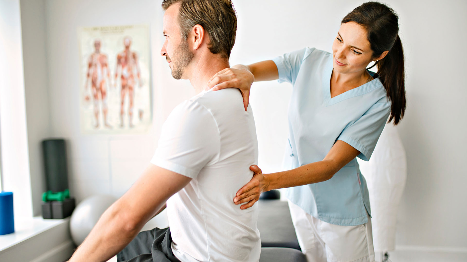 Nurse helping patient with lower back pain